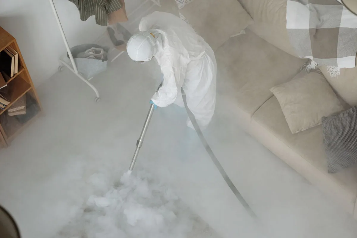 Biohazard cleanup technician in protective equipment, Holyoke, CO